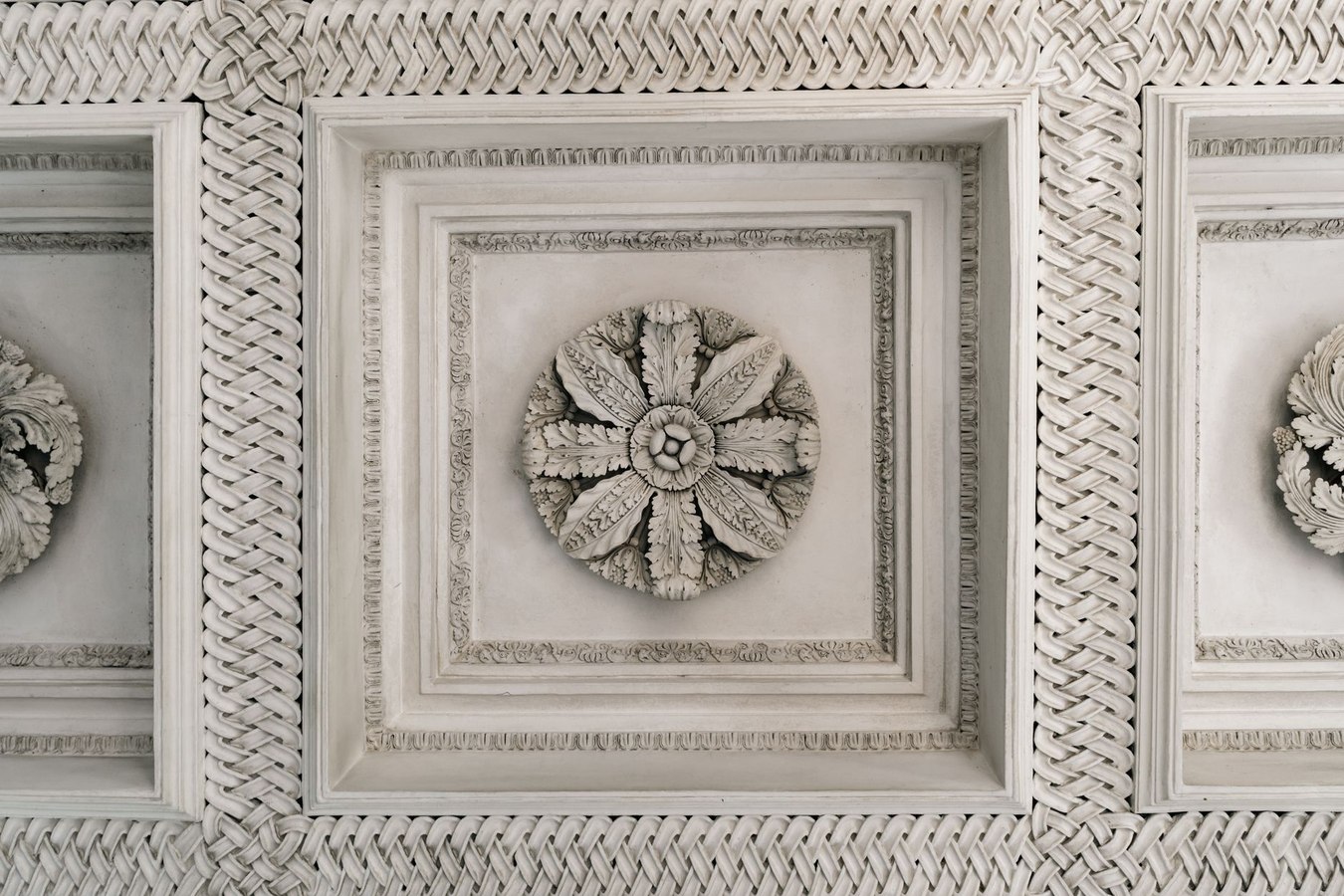 Macro detail of carved ornamental plaster with intricate moulding patterns